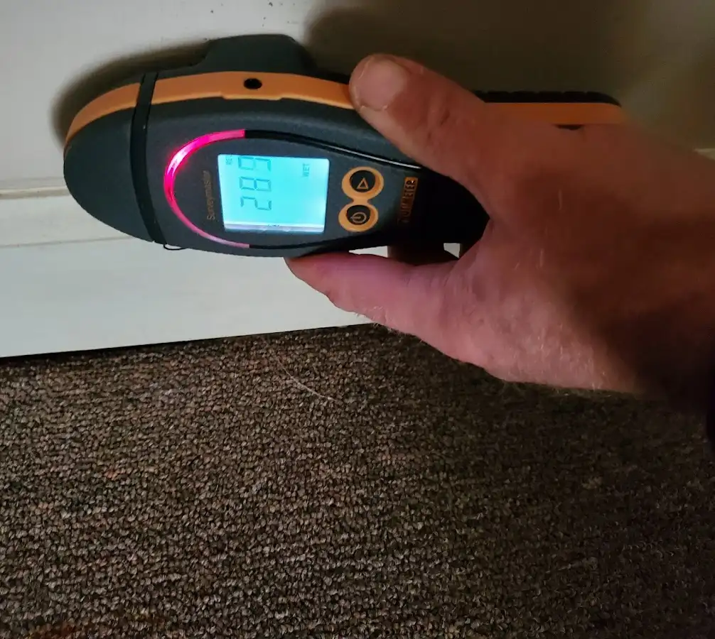 Moisture detection at baseboard during Storm Damage Restoration in Roswell
